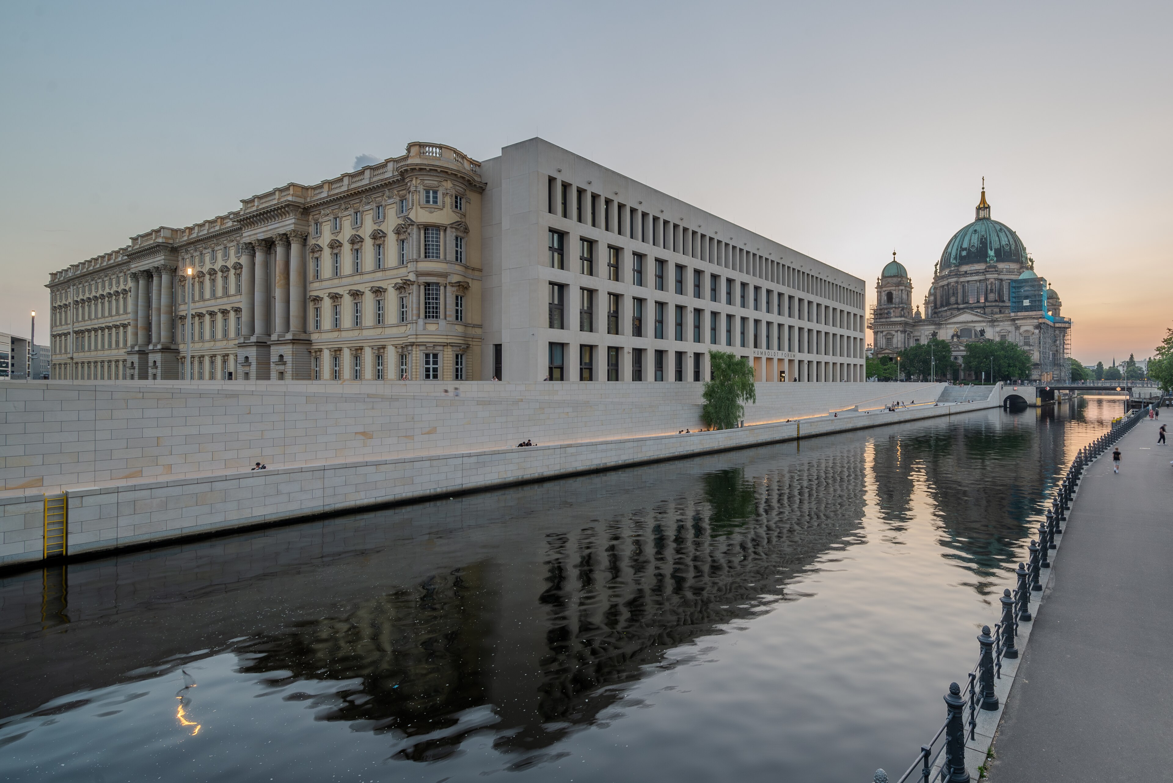 A contemporary European building of glass and folded stone